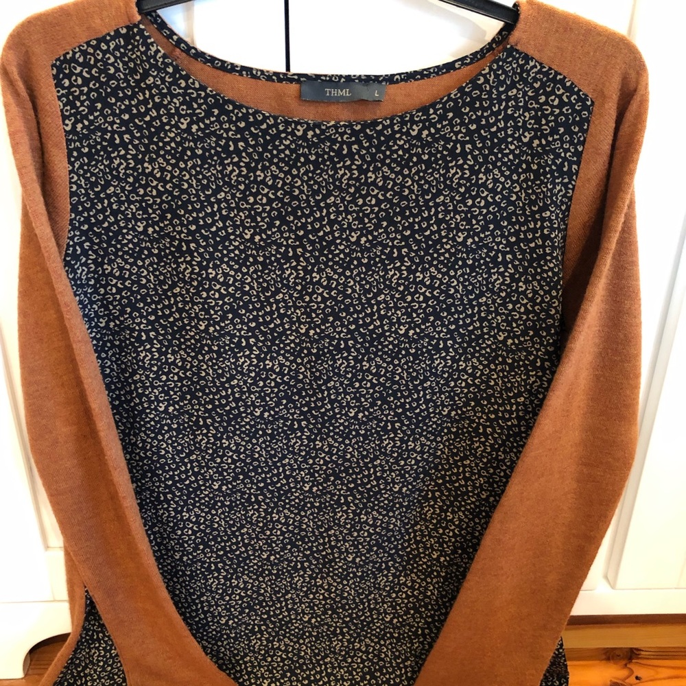 I have here a large lightweight long sleeve top by “THML”.